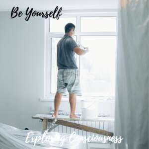 Man painting window with 'Be Yourself' text.
