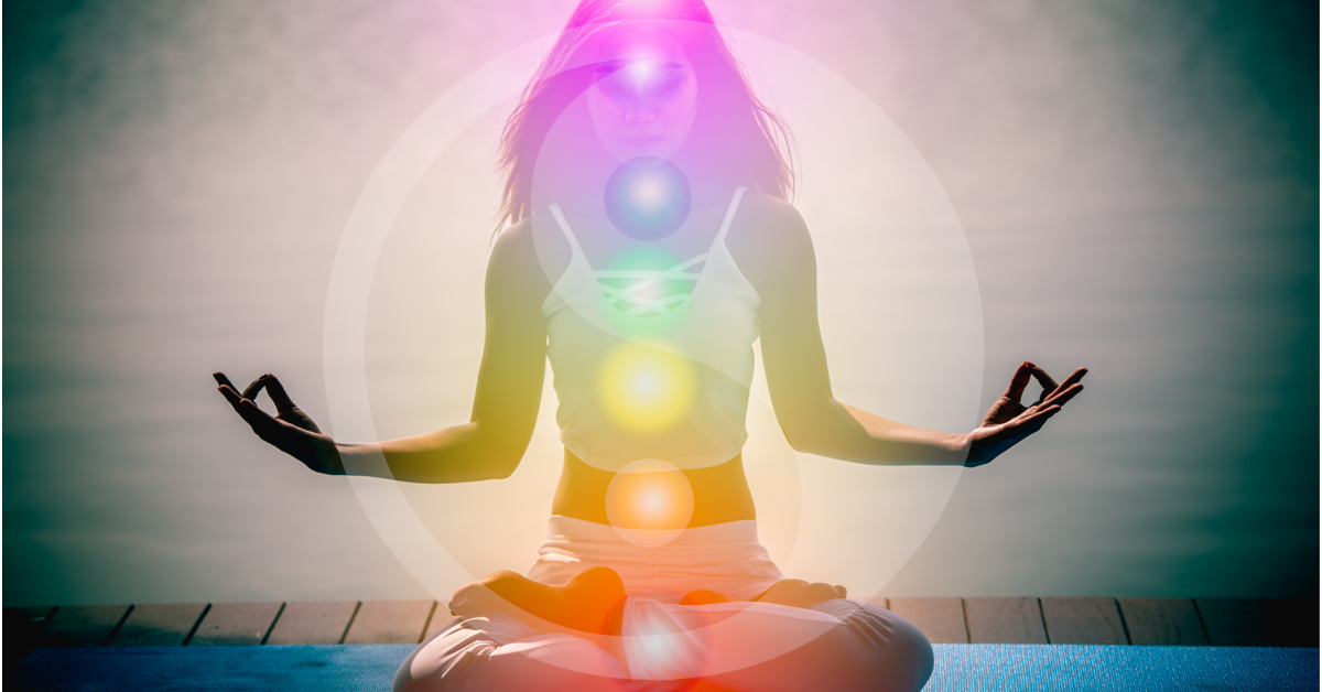 Woman meditating with chakra points highlighted.